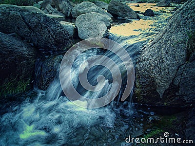 Small waterfall in mountain river Stock Photo