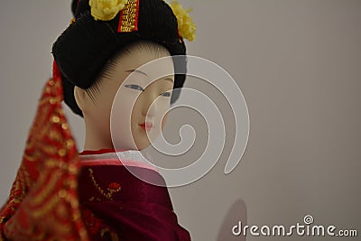 Geisha doll with a secret smile Stock Photo