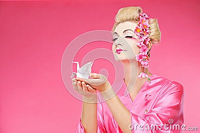 Geisha holding origami bird Stock Photo