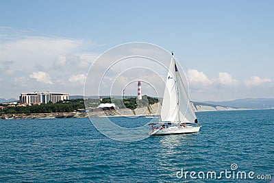 Gelendzhik, Russia a boat with a sail on the sea in the background thick Cape Editorial Stock Photo