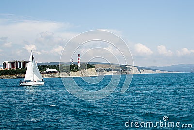 Gelendzhik, Russia a boat with a sail on the sea in the background thick Cape Editorial Stock Photo