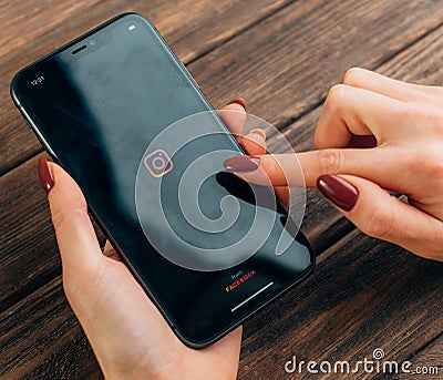 Gelendzhik, Russia, 20 February 2020: Woman launches the Instagram on an iPhone 11. Editorial Stock Photo