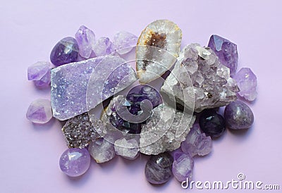 Gemstone minerals on a white background. Round tumbling minerals of amethyst and amethyst crystal Stock Photo