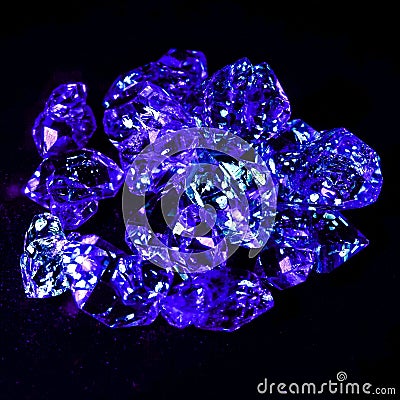 Gemstones with oil inside shining blue under a UV light Stock Photo
