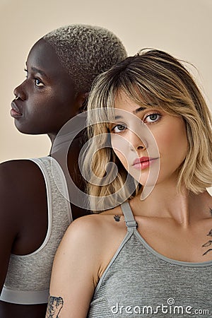 Gen z diverse girls beauty models faces on beige background, vertical portrait. Stock Photo