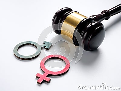 Gender discrimination concept. Male and female symbols near a gavel. Stock Photo