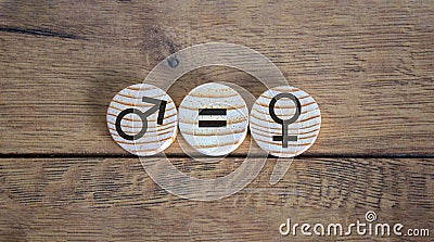Gender equality conceptual image. Male and female symbol on wooden circles on beautiful wooden background. Copy space Stock Photo