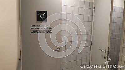 Gender neutral toilet symbol and sign on a door, in Dutch and English language Editorial Stock Photo