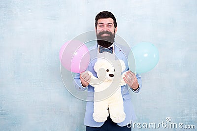 Gender reveal party. Traditional pattern of giving gifts. Valentines day. Romantic man with teddy bear and air balloons Stock Photo