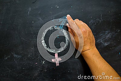 Gender symbols or signs for the male and female sex drawn on a blackboard Stock Photo