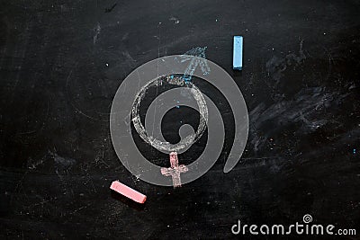 Gender symbols or signs for the male and female sex drawn on a blackboard Stock Photo