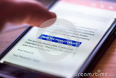 General Data Protection Regulation - GDPR - closeup human finger pointing to smartphone message button Read The Privacy Stock Photo