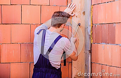 General maintenance and repair workers are hired for maintenance and repair tasks. Use hammer. Worker with hammer brick Stock Photo