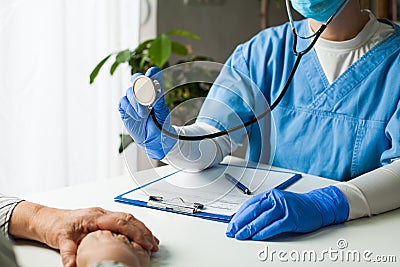 General Practitioner in doctor`s office, physician performing a blood pressure checkup Stock Photo