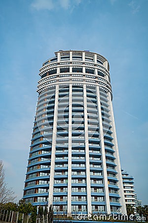 Cylindrical High-Rise Building with Tiered Balconies Stock Photo