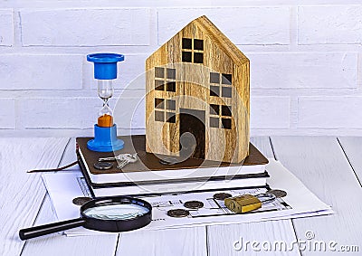 Home loan concept. Wooden house, hourglass, house keys, coins, magnifying glass, documents Generated image Stock Photo
