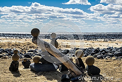 Pretty pile of wooden pebbles and balls of sand facing the sea Stock Photo
