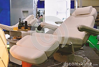 White chair for cosmetic procedures with electrically adjustable tilt and height. Stock Photo