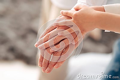 Hands of three generations being held together Stock Photo