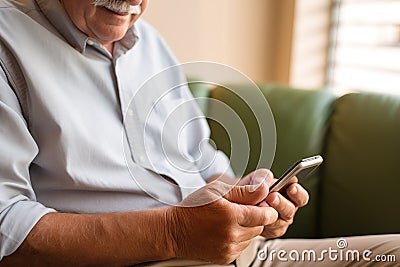 Generative Ai Image Showing Close Up Of Senior Man At Home Using Mobile Phone For Messaging And Browsing Stock Photo