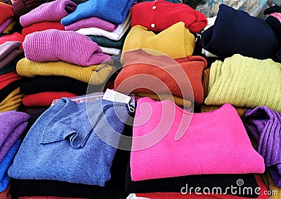 Colourful cashmere folded pullovers on an outdoors market stall Stock Photo