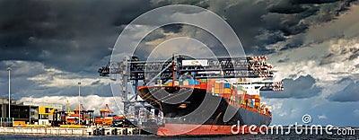 Generic container cargo ship berthed at wharf. Editorial Stock Photo