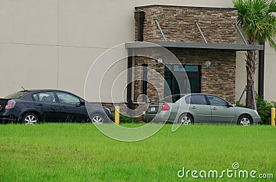 Generic drive thru pickup window with cars Stock Photo