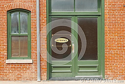 Generic entrance sign on green door window Stock Photo
