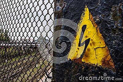 Generic High Voltage Danger Sign,symbol. Black arrow isolated in yellow triangle. Warning icon. Stock Photo