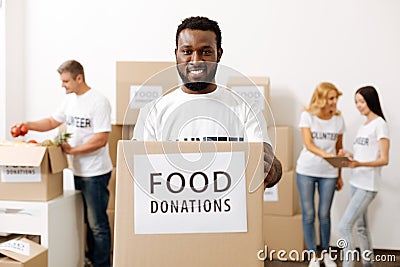 Generous lively man happy helping others Stock Photo