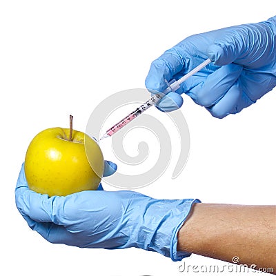 Genetic injection into apple isolated on white background. Genetically modified fruit and syringe Stock Photo