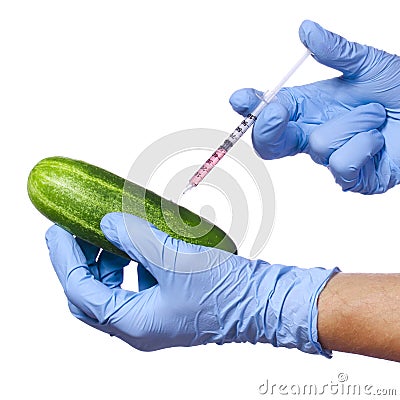 Genetic injection into cucumber isolated on white background. Genetically modified vegetable and syringe Stock Photo