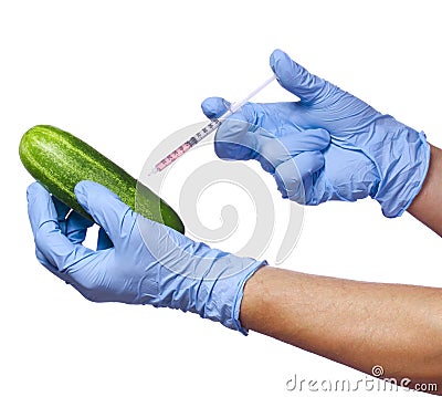 Genetic injection into cucumber isolated on white background. Genetically modified vegetable and syringe in his hands Stock Photo