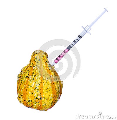 Genetic injection into pumpkin isolated. Genetically modified or unusually shaped squash with syringe. Stock Photo