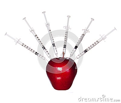 Genetically modified red apple and syringes isolated on white background. Genetic injection Stock Photo