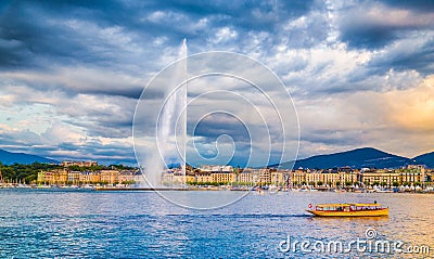 Geneva skyline with famous Jet d`Eau fountain and boat at sunset Stock Photo