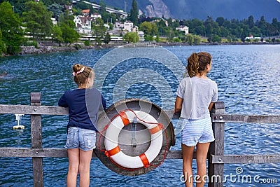 Geneve Lake Leman kid girl friends lifebuoy Swiss Stock Photo