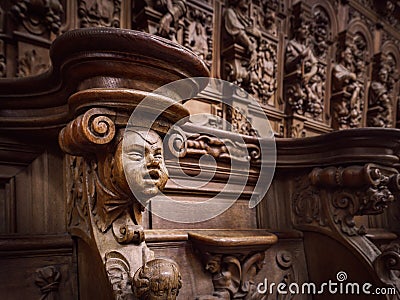 Genial wooden engraved silhouettes and faces in old Abbey Floreffe Stock Photo