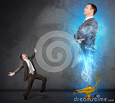 Genie business man appearing from magic lamp Stock Photo