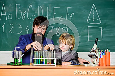 Genius kid. Joys and challenges raising gifted child. Teacher bearded scientist man child test tubes. Chemical Stock Photo