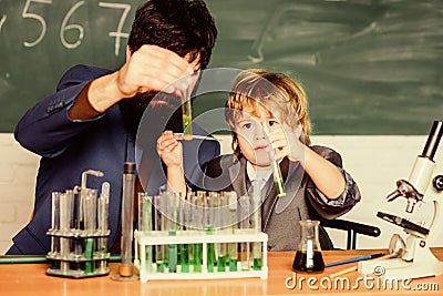 Genius minds. Signs your child could be gifted. Genius toddler private lesson. Genius kid. Teacher child test tubes Stock Photo