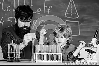 Genius minds. Genius toddler private lesson. Genius kid. Teacher child test tubes. Achieving developmental milestones Stock Photo