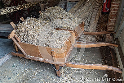 Wooden wheelbarrows loaded with straw, Domein Bokrijk, Genk, Belgium Stock Photo