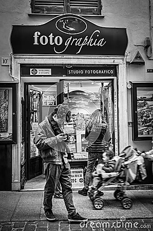 Genoa, Italy - April 21, 2016: Photographer looking at his photo Editorial Stock Photo