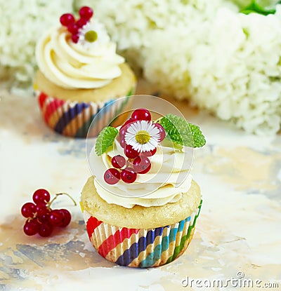 Gentle cupcake with cream and berries on a light background Stock Photo