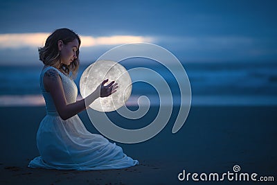 Gentle image of a girl, Astrology, Female magic. Beautiful attractive girl on a night beach with sand hugs the moon, art Stock Photo