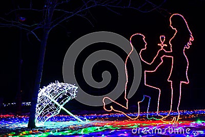Gentle and romantic contours of a man on his knee who makes a proposal to the woman about the engagement, made by LED tape Stock Photo