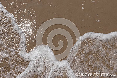 Gentle wave on sandy beach. Stock Photo