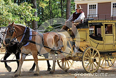 Gentleman dressed in period clothing taking visitors for wagon ride,Old Sturbridge Village,September 2014 Editorial Stock Photo