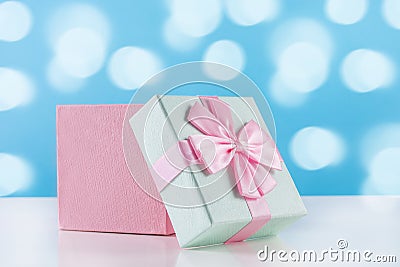 Adorable Baby Gift: Pink Present Box with Bow on White Desk Stock Photo